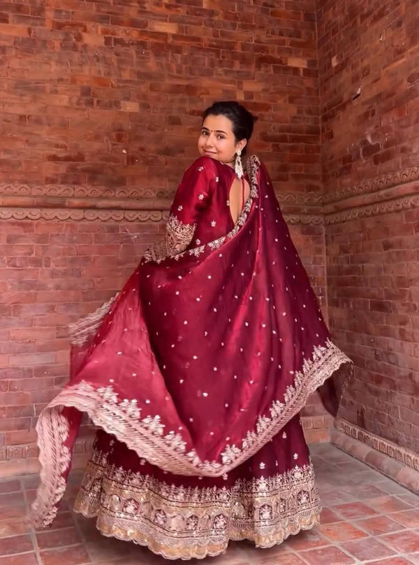 Elegance in Maroon Against Urban Backdrop