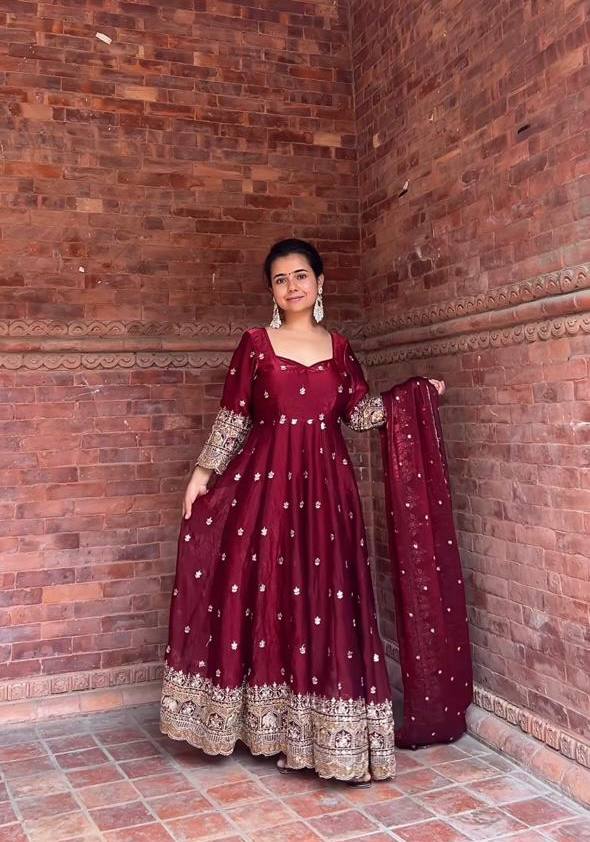Elegance in Maroon Against Urban Backdrop