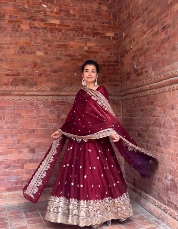 Elegance in Maroon Against Urban Backdrop