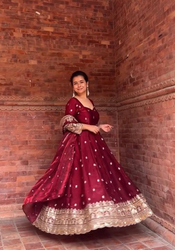 Elegance in Maroon Against Urban Backdrop