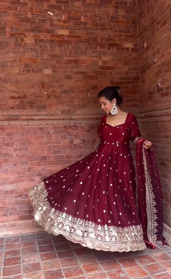 Elegance in Maroon Against Urban Backdrop